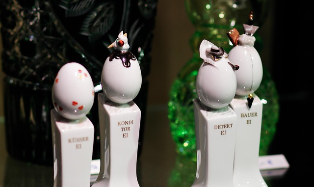 Elegant display of antique porcelain and ceramics, Meissen figures, Wedgwood jasperware, delicate teacups, soft museum lighting